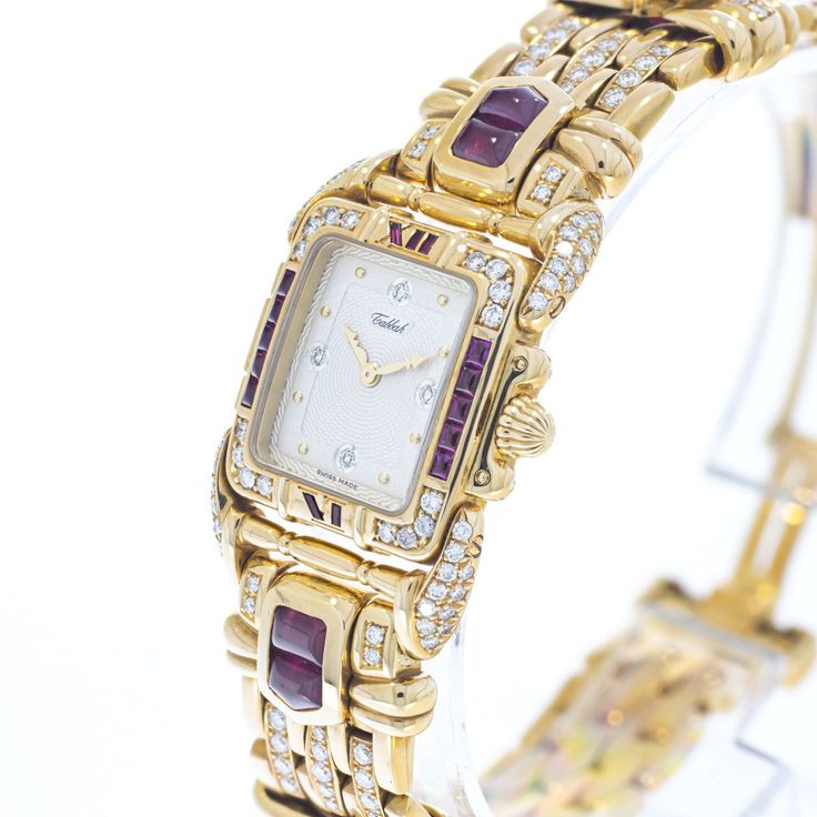 Pre-owned in very good condition Lady’s Tabbah Saga de Tabbah collection known for its unique and modern style, this amazing Swiss-made watch features an elegant rectangular case crafted from precious 18K Yellow Gold and measures approximately 25mm (from end of case to end of crown) x 6.5mm (high). The case is topped with an amazing Diamond-studded 18K Yellow Gold bezel and Rubies approximately 4.87 cts. Behind the high-quality crystal is a superb White guilloche dial with applied dots hour mark Luxury Hallmarked Evening Watches, Formal Yellow Gold Diamond Watch With Rectangular Shape, Luxury Hallmarked Diamond Watch For Evening, Luxury Hallmarked Diamond Watch For Evenings, Elegant Yellow Gold Rectangular Watch, Yellow Gold Rectangular Diamond Watch For Evening, Luxury Yellow Gold Rectangular Diamond Watch, Rectangular Yellow Gold Diamond Watch, Designer Jewelry With Rectangular Dial For Formal Occasions