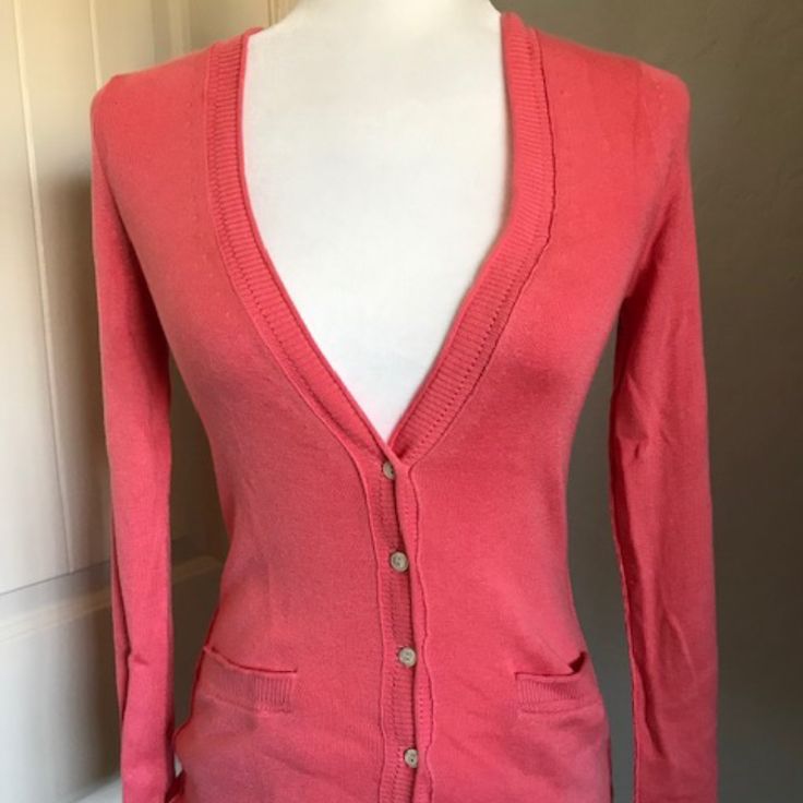 Banana Republic Coral Cardigan. Size Xs Nwt 52% Silk 13% Cotton 35% Polyester Deconstructed Seaming With Ribbed And Pointelle Trim Length From Top Of Shoulder Seam 24” Sleeve Length From Shoulder Seam 23” Bust 28” Stretches To 38” Waist 24” Stretches To 39” Sweep 28” Stretches To 40” Fitted V-neck Outerwear For Day Out, Fitted V-neck Cardigan With Pockets, Trendy V-neck Cardigan For Daywear, Fitted Cotton Cardigan With Pockets, Fitted Button-up Cardigan With Pockets, Classic Fitted Sweater With Pockets, Fitted Long Sleeve Cardigan For Spring, Elegant V-neck Cotton Cardigan, Trendy Fitted Cotton Cardigan