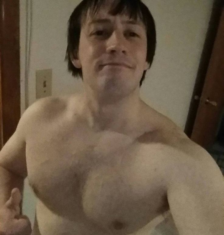 a shirtless man with no shirt on taking a selfie