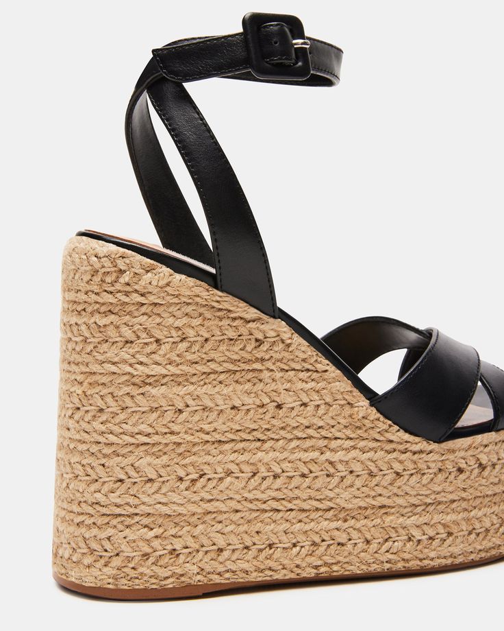 Elevate your style with LULAH sandals. Featuring a raffia sole and a comfortable wedge, these sandals are perfect for any summer adventure. The crisscross front strap and ankle strap add a touch of elegance, while the platform provides extra support. 5 inch heel height 2 inch platform Leather upper material Synthetic lining Synthetic sock Synthetic sole Imported Strappy Synthetic Wedge Sandals For Vacation, Beach Wedge Heel Sandals With Heel Strap, Chic Strappy Wedge Sandals For Vacation, Summer Synthetic Strap Wedge Sandals, Wedge Heel Sandals With Heel Strap For Beach, Chic Strap Sandals For Beach, Chic Straw Wedge Sandals With Ankle Strap, Chic Wedge Sandals With Strap And Round Toe, Cross Strap Wedge Sandals For Summer Beach