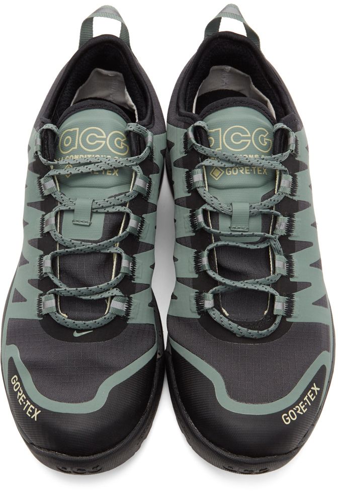 Low-top waterproof Gore-Tex® ripstop sneakers in black. Tonal and green bonded trim throughout. Logo printed in yellow at round toe. Swoosh in green at vamp. Reflective stripes in silver-tone at green and grey lace-up closure. Logo printed in yellow at padded tongue. Swoosh printed in yellow at outer side. Logo and text printed in green and black at inner side. Webbing pull-loop in green featuring reflective stripe in grey at heel tab. Logo printed in yellow and black at heel counter. Speckled r Nike For Men, Grey Lace, Nike Green, Yellow And Black, Green And Black, Nike Outfits, Gore Tex, Luxury Streetwear, Low Top