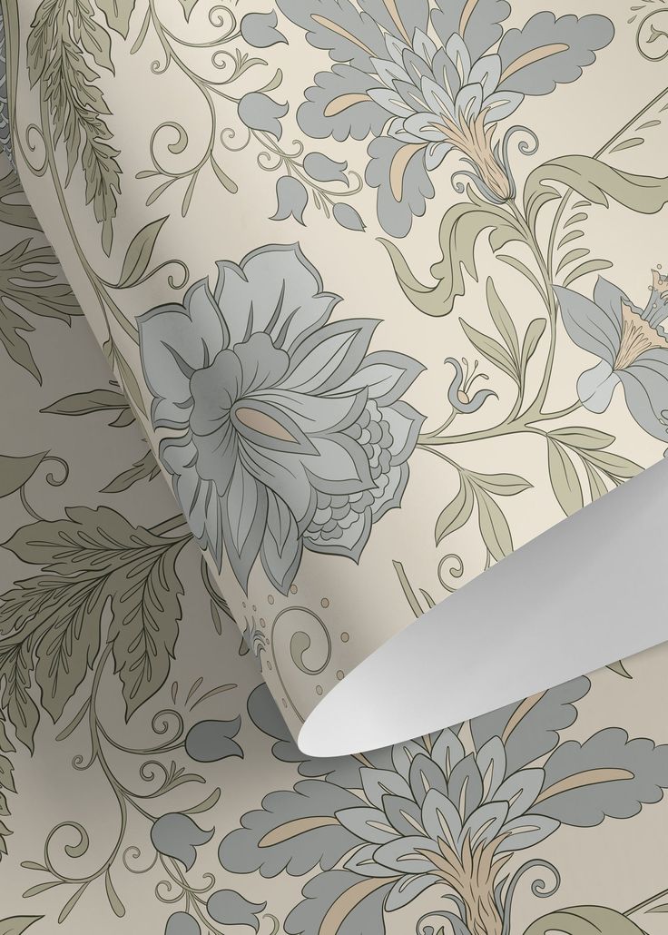 a knife is laying on top of a floral wallpaper