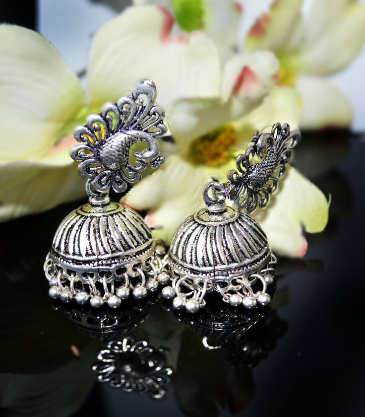 These are beautiful artisan handmade Jhumkas. The celebrity is wearing a similar styled piece but not the same. These are Beautiful jhumkas and are not heavy as they might seem.  ** Bollywood actress picture courtesy Google. These are a statement style piece. Wear them on your little black dress or ethnic clothes and rock it . Thank you for your support Go back to Storefront Taneesijewelry.etsy.com  View my Entire STERLING SILVER EARRINGS Collection at https://www.etsy.com/shop/taneesijewelry?se Navratri Peacock Design Jhumkas, Chandbali Danglers With Peacock Design, Gift Peacock Design Jhumkas, Bollywood Silver Jhumkas With Peacock Design, Silver Peacock Design Jhumkas For Navratri, Silver Jhumkas With Peacock Design, Festive Silver Jhumkas With Peacock Design, Silver Jhumka Earrings, Dome Chandelier