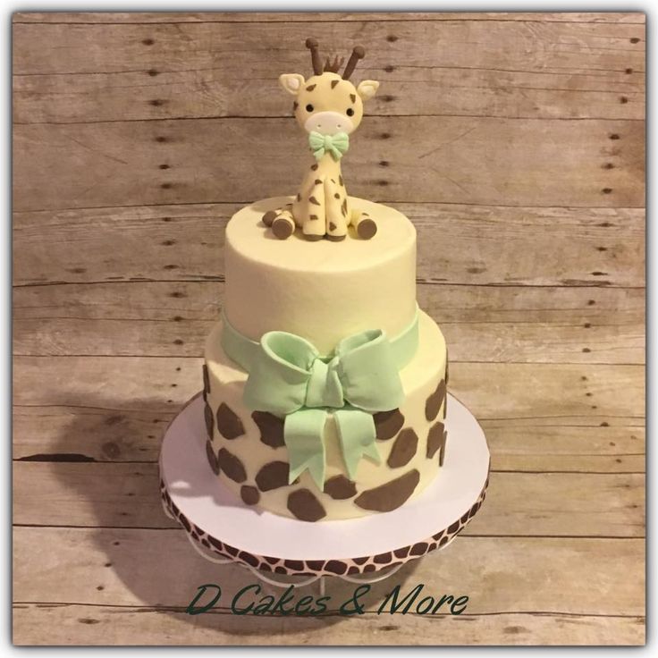 a giraffe cake with green bow on top