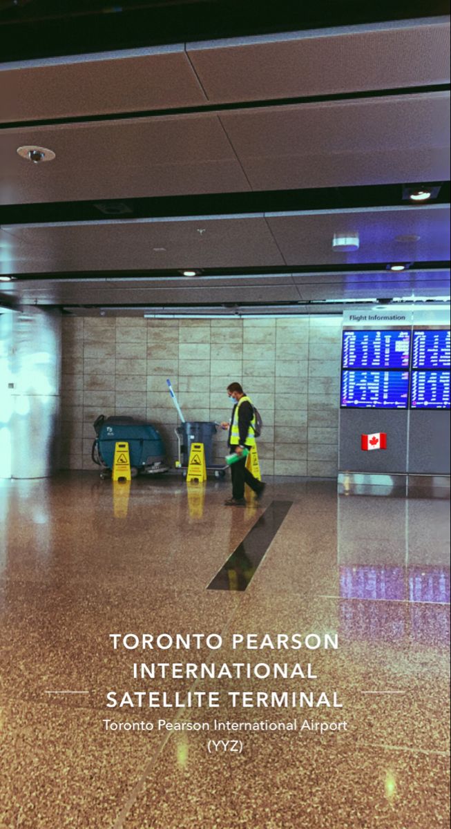 a man in yellow vest walking through an airport