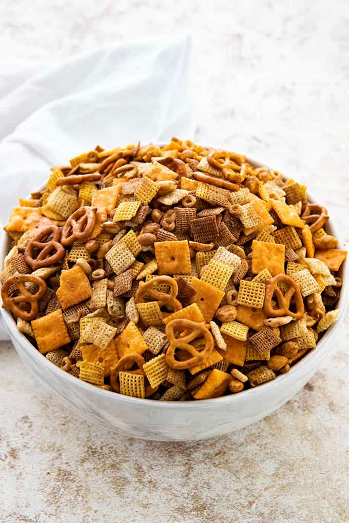 a white bowl filled with cheetos and pretzels