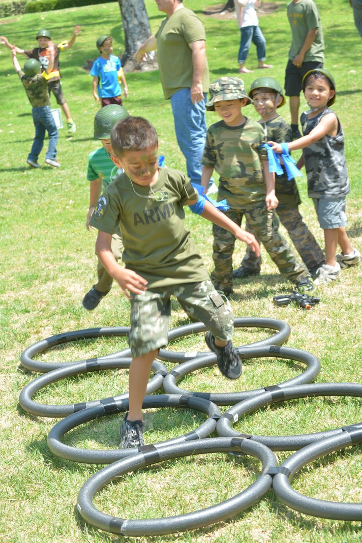 a group of young children playing in the grass