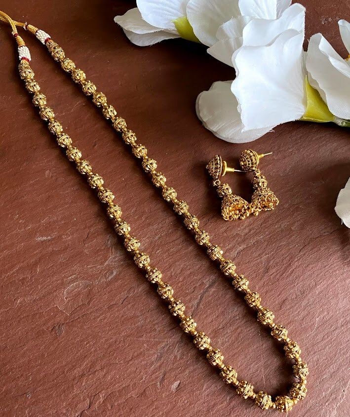 24 K gold plated beaded long necklace with matching delicate earrings Highest quality and craftsmanship Indian Bridal Traditional One Gram Jewelry Necklace Set. 3 line Length : 16 inches 2 line Length: 24 inches 1 line Length : 30 inch All the raw material used in this product is of high quality and is handcrafted with love. Premium Quality and High craftsmanship 100% Satisfaction Guarantee: Long Lasting Plating, High-Quality Stones. Gifting: This pair of charming necklace and earrings come in a Gold Beaded Chain Earrings For Wedding, Gold Temple Jewelry Chain Necklace Gift, Gold Temple Jewelry Style Chain Necklace, Gold Dangle Jewelry Sets For Festive Occasions, Gold Bead Dangle Jewelry For Jewelry Making, Gold Brass Beaded Necklace With Round Beads, Traditional Gold Earrings With Faceted Beads, Gold Temple Jewelry Chain Necklace For Wedding, Gold Dangle Jewelry Sets For Celebration