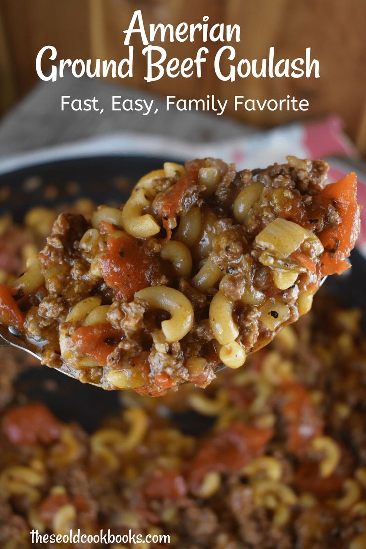 a spoon full of ground beef goulash is being held up over a skillet