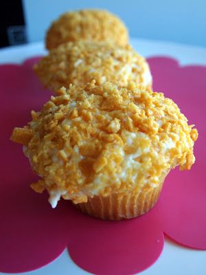 two cupcakes on a pink and white plate