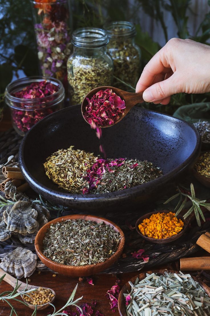 a person scooping out herbs from a bowl