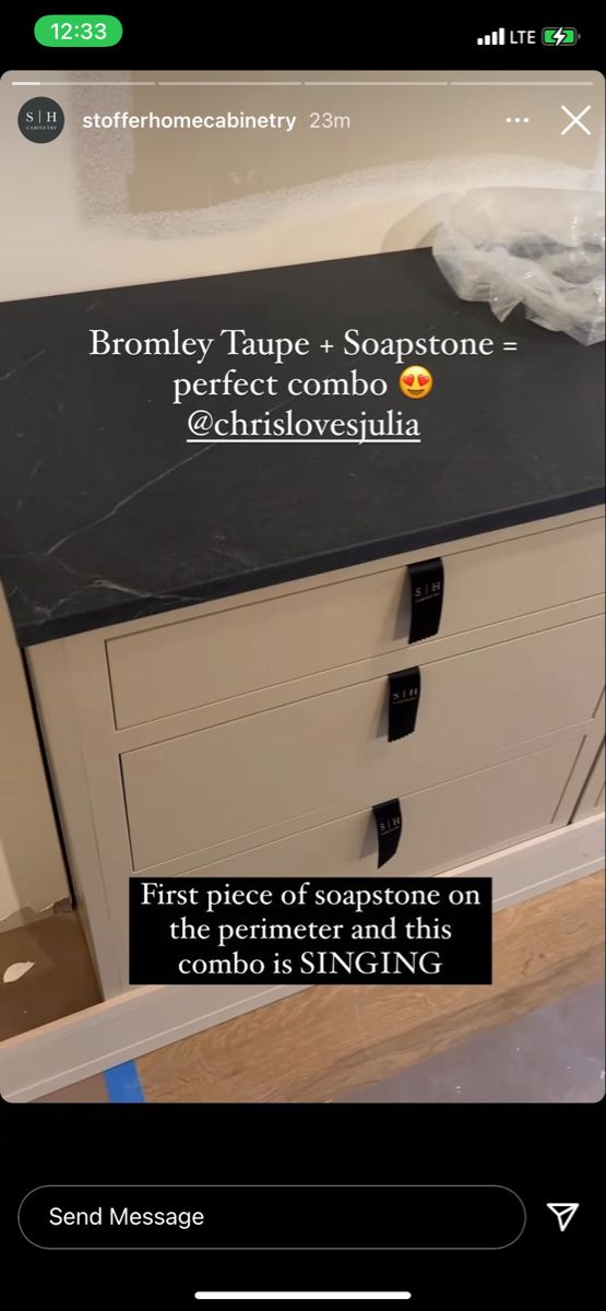 a black counter top sitting on top of a wooden floor next to a bath tub