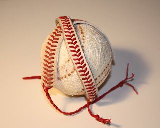 an old baseball with red stitching on it