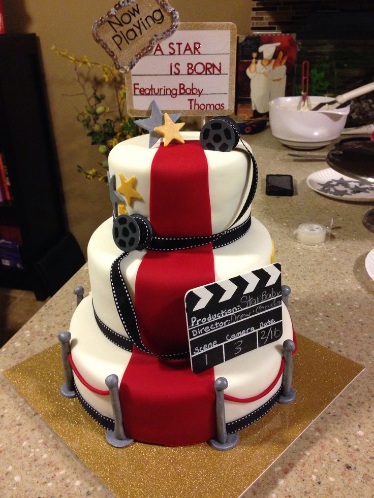 a three tiered cake with a movie theme on it