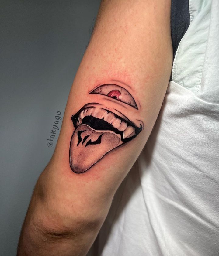 a man with a tattoo on his arm has a black and white image of a woman's mouth