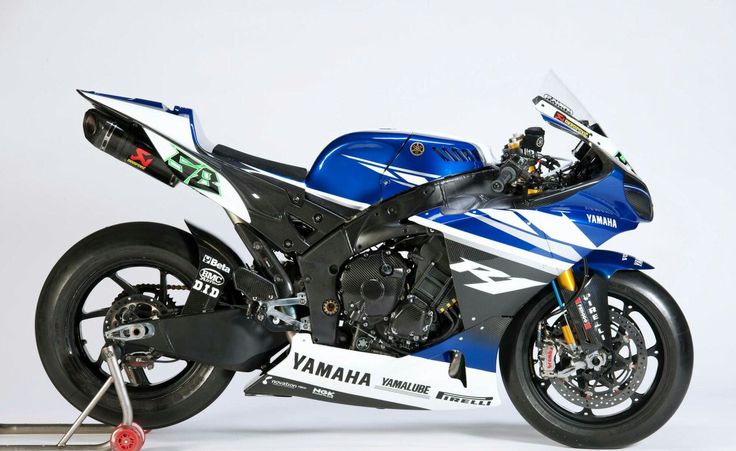 a blue and white motorcycle parked in front of a white background with the words yamaha on it