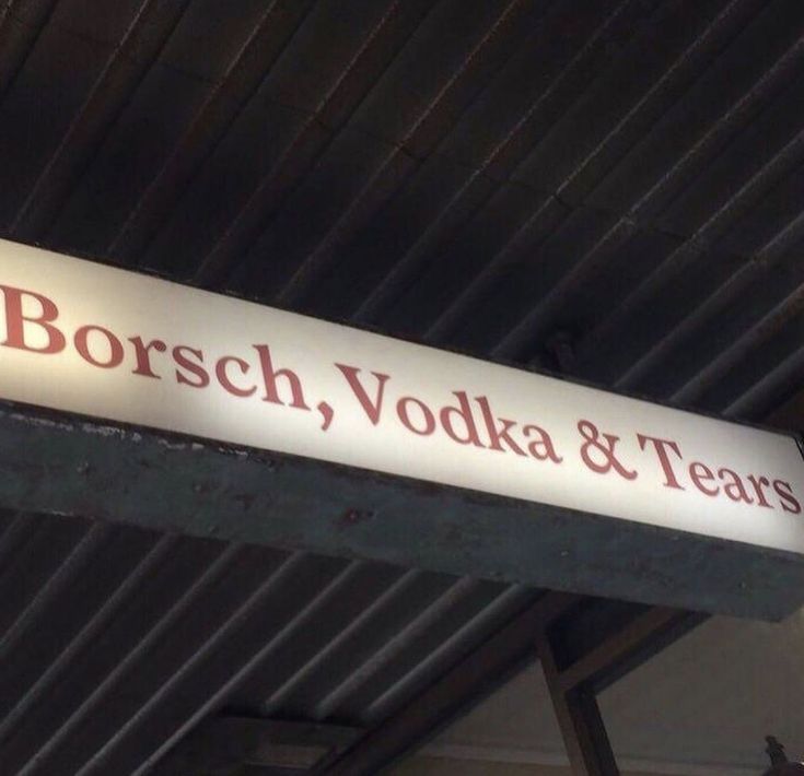 the sign for borsch, vodka and tears hangs from the ceiling above it