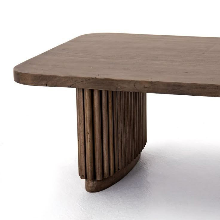 a wooden table sitting on top of a white floor