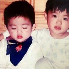 two young boys sitting next to each other