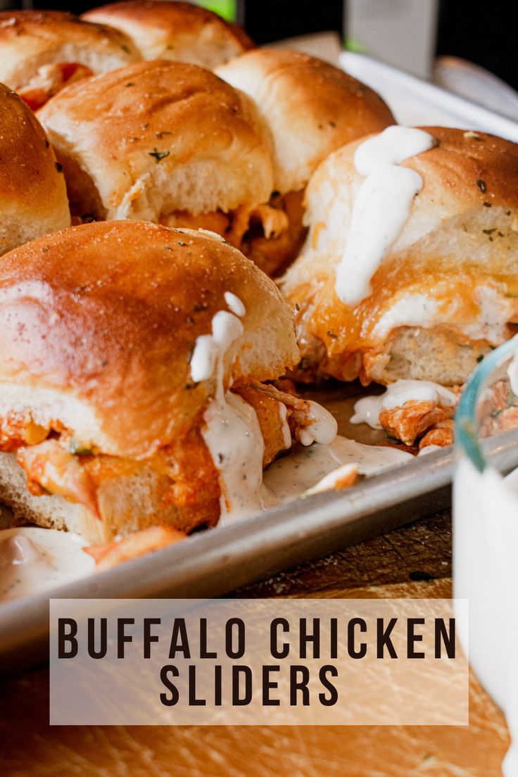 buffalo chicken sliders on a tray with ranch dressing