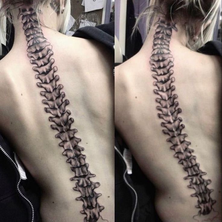 the back of a woman's neck with a tattoo design on her left side