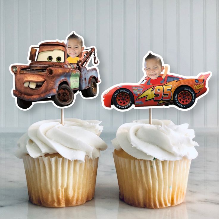 two cupcakes that have cars on them