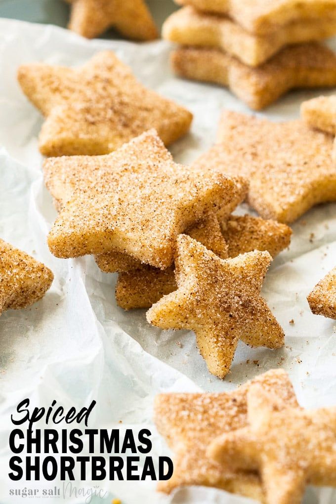 homemade christmas shortbread stars on parchment paper with the words spiced christmas shortbread written below