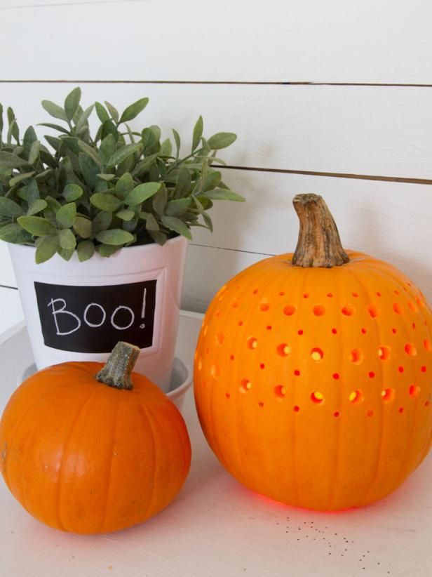 two pumpkins sitting next to each other on a table