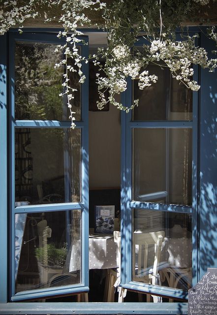 an open window in front of a tree