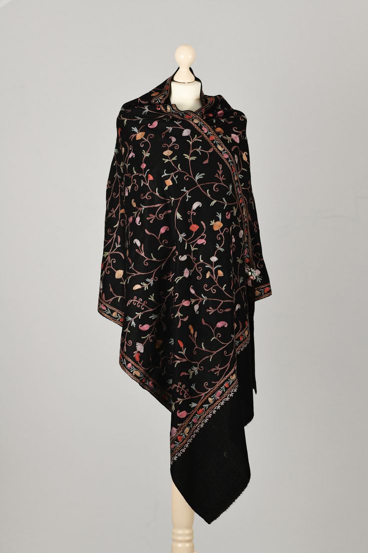 Black super soft wool Scarf, embroidered with Orange and Rose with small pieces of Red velvet fabric in traditional Kashmiri Floral design with Silk viscose yarn.   Highlights *Handmade in Kashmir  *Materials: Super Soft lightweight Wool, Embroided with Silk and viscose  *Length: 200 cm  *Width: 70 cm  Description Elegant and authentic Kashmiri scarf in Super Soft wool embroidered with Orange and Rose with small pieces of Red velvet fabrics with Silk viscose yarn.  Extremely comfortable to wear. Perfect for everyday or formal use.  This scarf is produced in a small family-owned business for the past five generations.  The colors of the shawls may differ slightly from those shown in the photos due to the light conditions and monitor calibration. Washing Instructions: Dry clean only. Please Black Wool Scarf, Traditional Floral Design, Red Velvet Fabric, Embroidery Traditional, Scarf Handmade, Rose Embroidery, Personalized Embroidery, Floral Scarf, Formal Attire