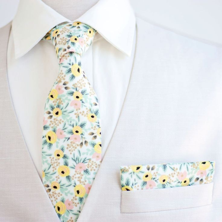 "Dapper Men's Rosa In Cream Necktie Made By The Belle And The Beau! ♥ This beautiful cotton floral fabric is part of our new Primavera Collection designed by Rifle Paper Co! We have been approved by Rifle Paper Co to make our products in these fabrics- that means we will be ordering bolts regularly! Yay! Our dapper, modern, stylish, and charming neckties are perfect for everyday, Sunday best, all special occasions, photography sessions, and especially dapper on grooms and groomsmen! They are the Dapper White Suit And Standard Tie Accessories, Dapper White Ties For Grooms, Dapper White Ties For Groom, Dapper Ties For Groom On Father's Day, Dapper White Tie For Groom, Groom Ties For Father's Day, Dapper Ties With Pocket Square, White Ties For Black Tie Events On Father's Day, White Tie For Black Tie Events