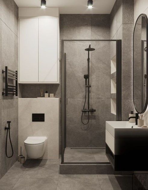 a bathroom with a toilet, sink and shower stall in the middle of the room