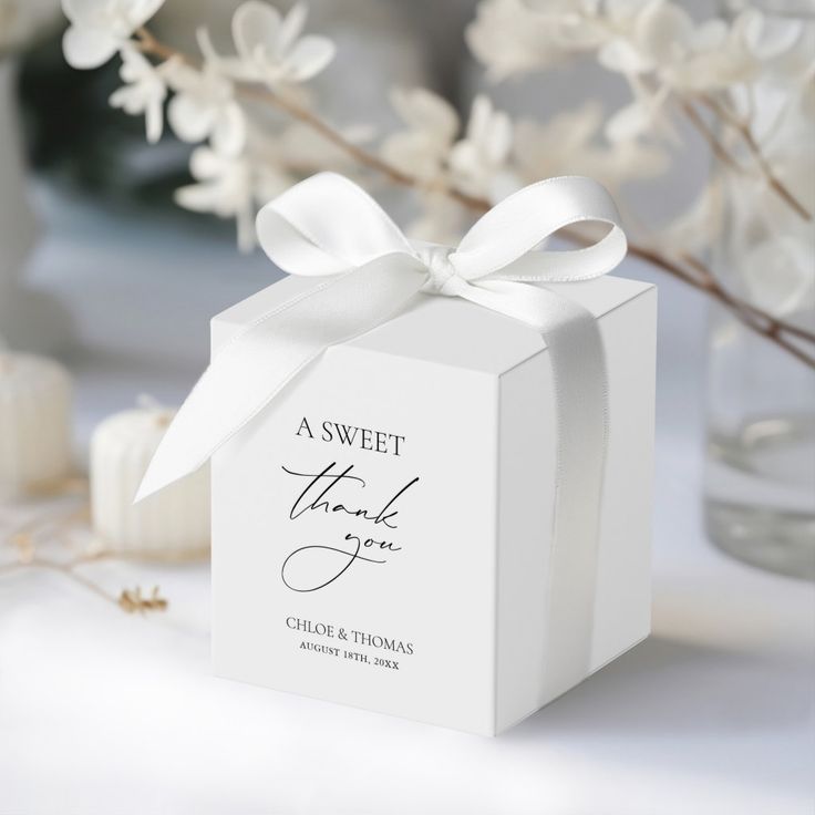 a small white box with a bow on the top that says, a sweet thank