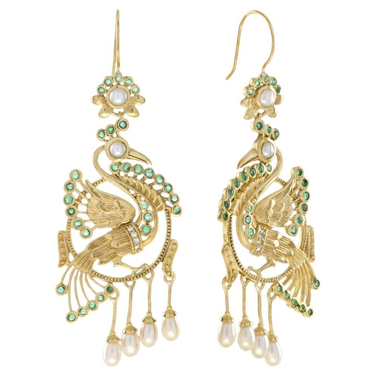 Let these beautiful birds bring you joy in more way than one. The peacock represents happiness. Dangle our Peacock Earrings from your lobes as exotic statement pieces. These detailed and layered earrings are in 14k yellow gold. The earrings feature emerald, diamond and peal that will shimmy along with you. Information Metal: 14K Yellow Gold Width: 25 mm. Length: 69 mm. Weight: 13.80 g. (approx. in total) Backing: French Wire Gemstones I Type: Emerald Shape: Round Size: 1.3 - 1.8 mm. Number: 62 Weight: 1.56 Carat (approx. in total) Gemstones II Type: Diamond Shape: Round Size: 1.1 mm. Number: 8 Weight: 0.05 Carat (approx. in total) Gemstones III Type: Pearl Shape: Round & Drop Size: 3.5 – 5 mm. Number: 12 Weight: 2.96 Carat (approx. in total) These earrings will be made to your order in 1-2 Luxury Traditional Bridal Earrings With Peacock Design, Layered Earrings, Peacock Earrings, Pearl Dangle Earrings, Earring Box, The Peacock, French Wire, Pearl Earrings Dangle, Emerald Diamond