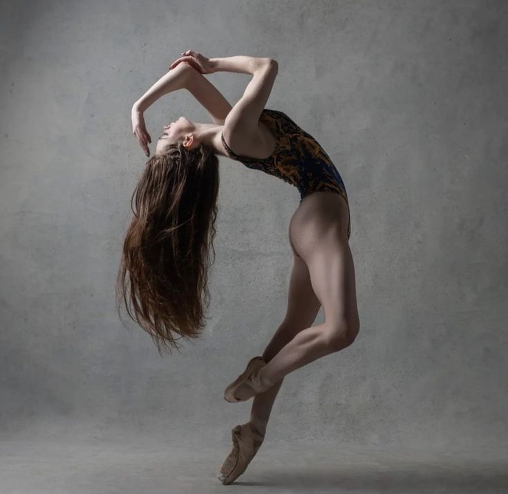 a woman in leotards is doing a dance move