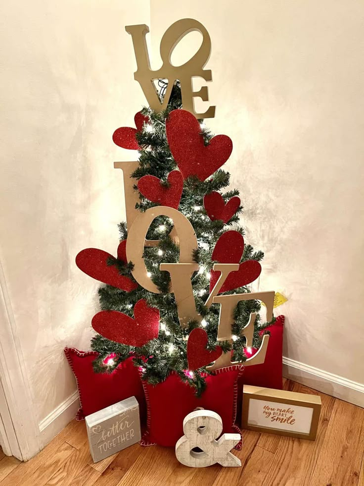 a christmas tree decorated with red hearts and love letters