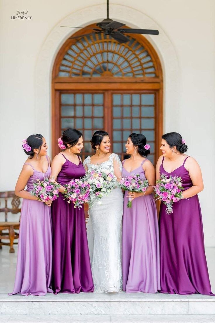 the bride and her bridesmaids are all dressed in purple