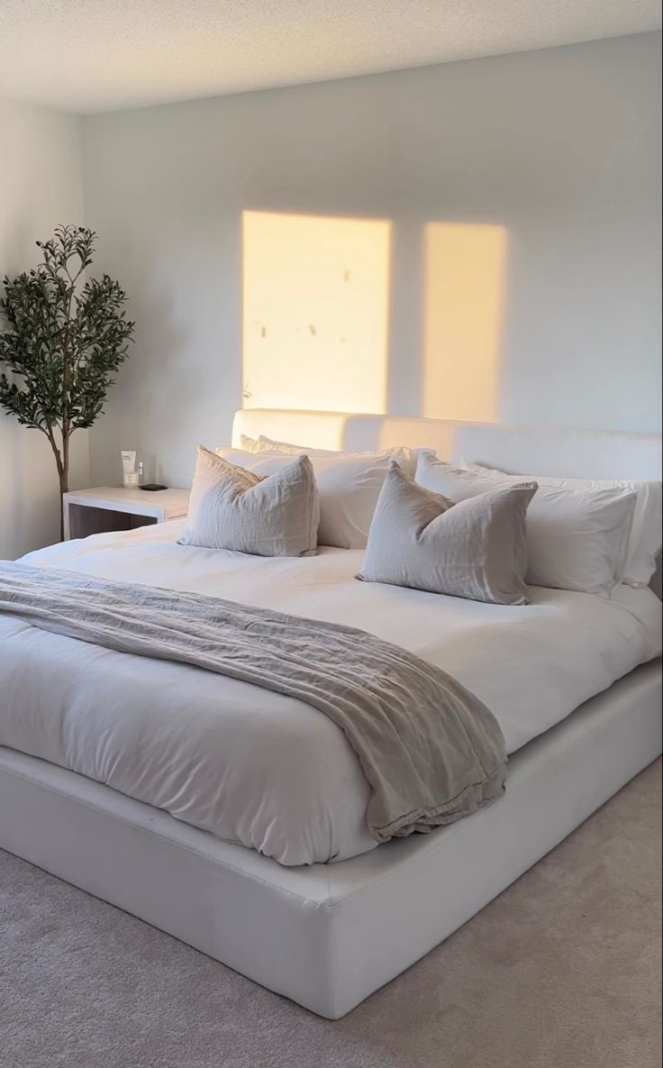 a large bed sitting in the middle of a bedroom