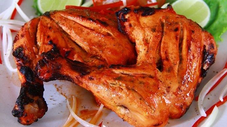 a plate with some chicken and vegetables on it, ready to be eaten by someone