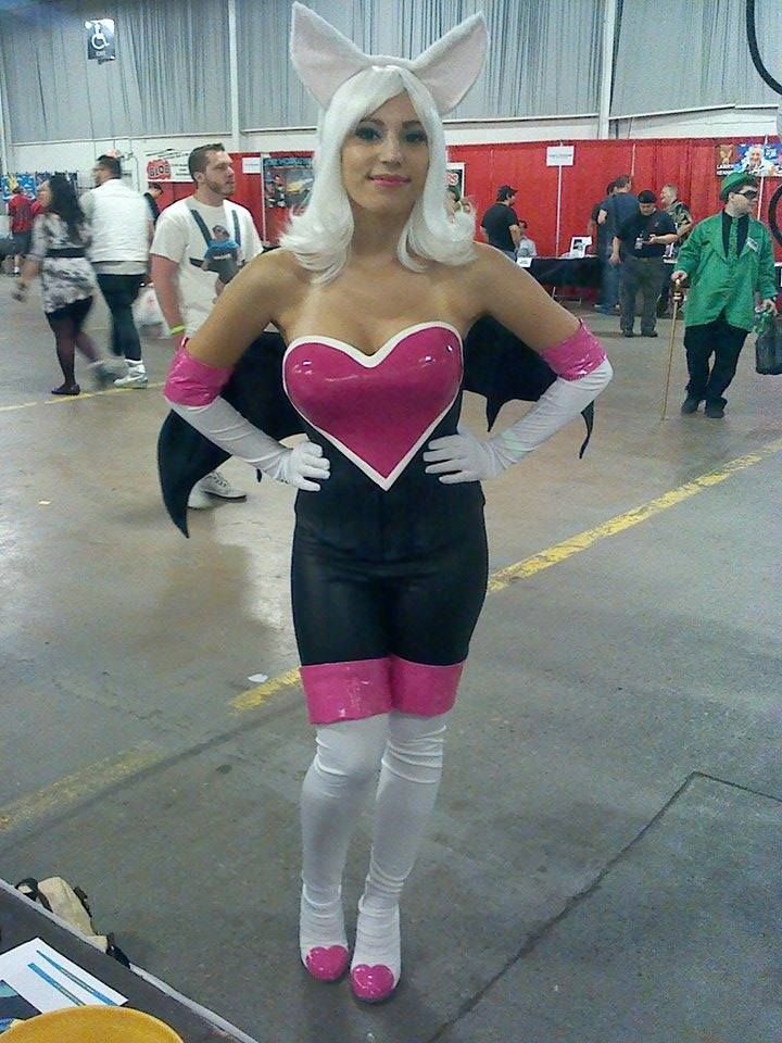 a woman dressed in costume standing next to a table