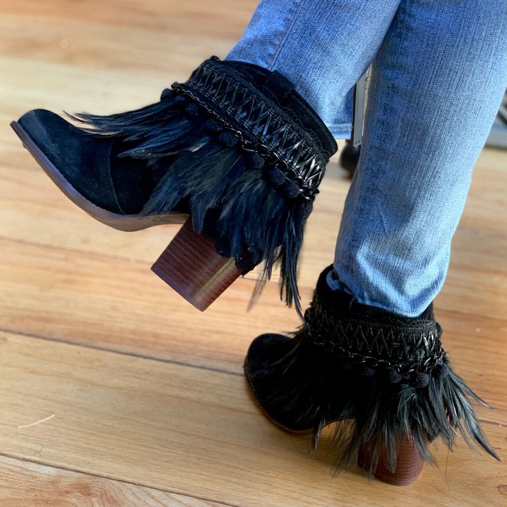 A square toe and blocky heel put a chic twist on a Western bootie handcrafted and embellished to be unique on soft black suede.Fits true to size. Bohemian Suede Boots With Tassels, Trendy Suede Boots With Block Heel, Party Heeled Boots With Stacked Low Heel, Bohemian Suede Ankle Boots, Chic Suede Boots With Block Heel, Chic Black Boots With Fringe, Suede Booties With Stacked Low Heel, Suede Block Heel Boots For Party, Party Suede Heeled Boots With Block Heel