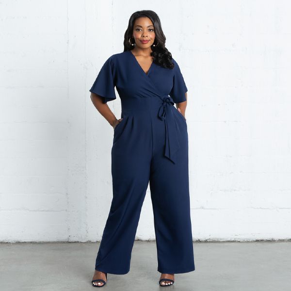 Jump from work to a wedding on the weekend in our Charisma Crepe Jumpsuit. Designed with a surplice neckline, short flutter sleeves and a detachable tie at the waistband. Pleated detail at the front and back of pant adds a tailored appearance. A zipper in the back makes getting in and out a breeze.  The ideal jumpsuit for any occasion, you’ll love this one and done style. Plus Size Shift Dress, Dresses Materials, Casual Work Dresses, One And Done, Crepe Jumpsuit, Surplice Neckline, Plus Size Jumpsuit, Swimsuits For All, Trouser Style