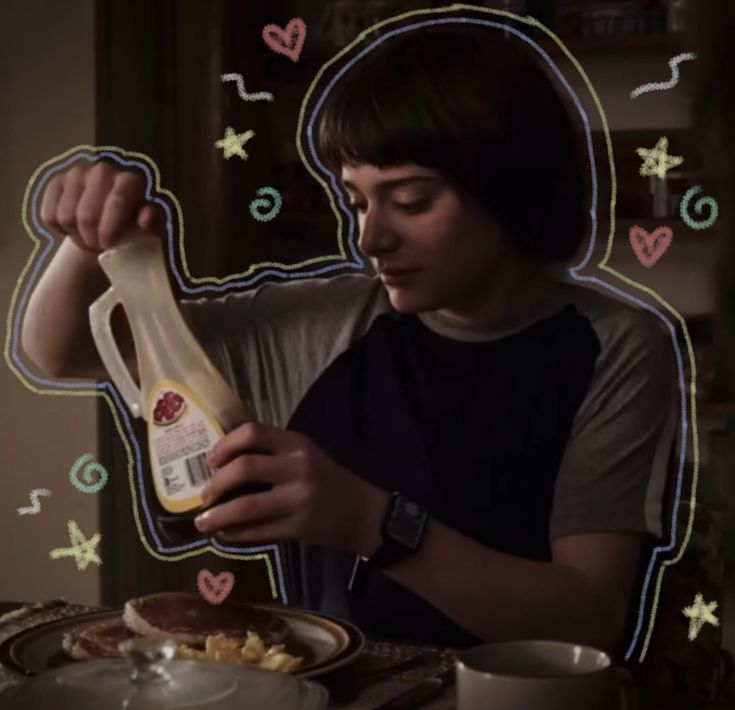 a woman is holding up a bottle of food