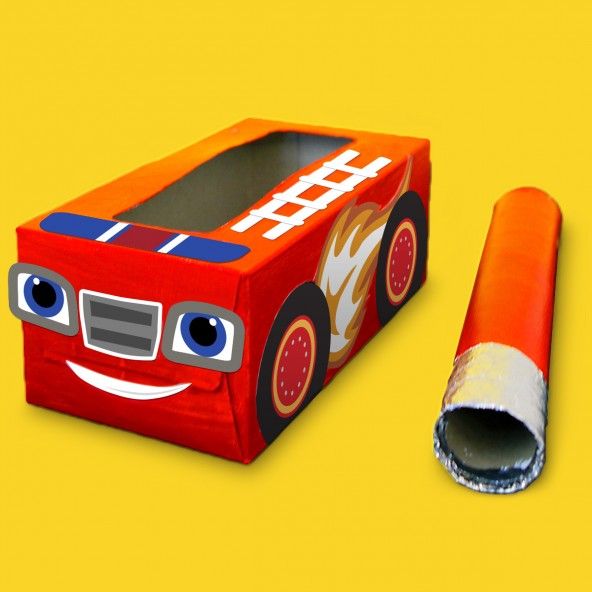 a cardboard box with a fire truck design on the side and a roll of tape in front of it