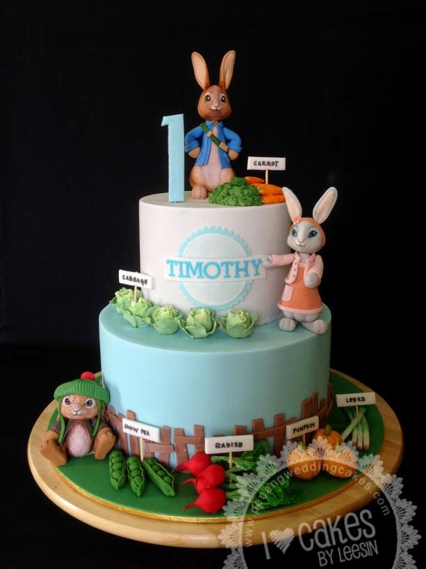 a birthday cake decorated with bunnies, rabbits and the number one on it's side