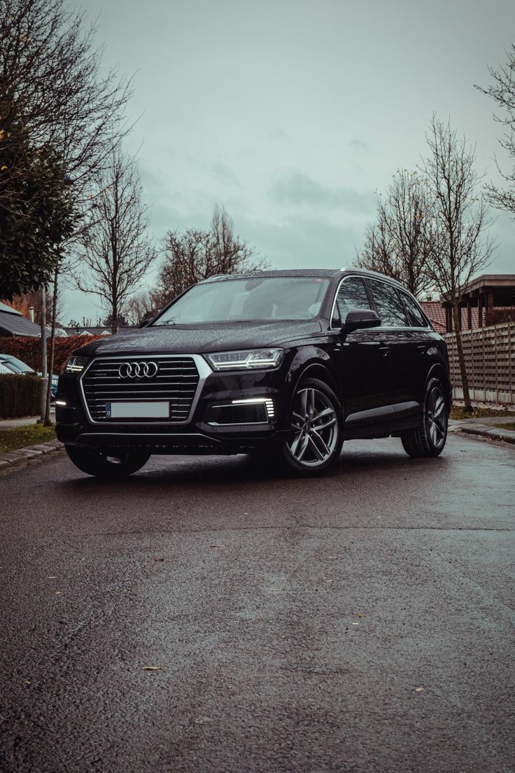 an audi suv is parked on the street