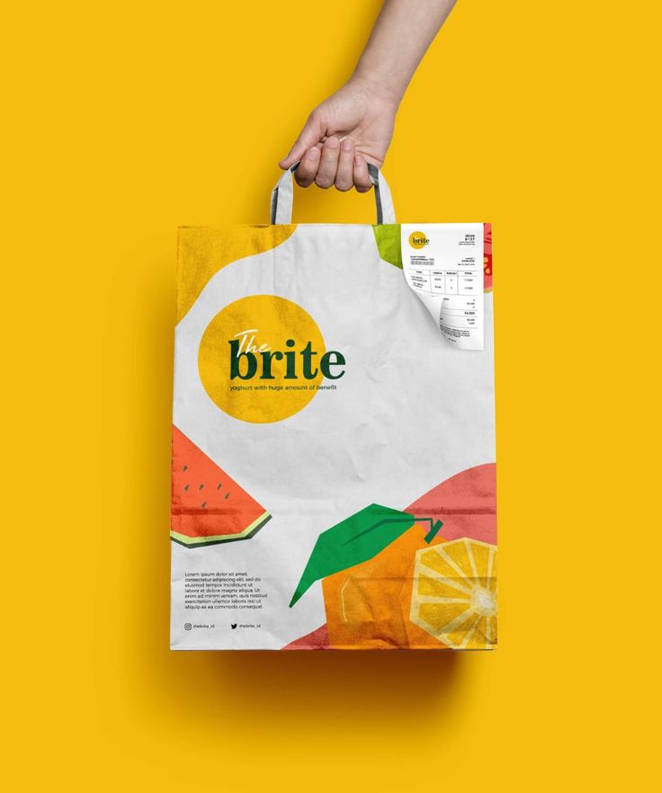 a person's hand holding a white shopping bag with oranges and watermelon on it