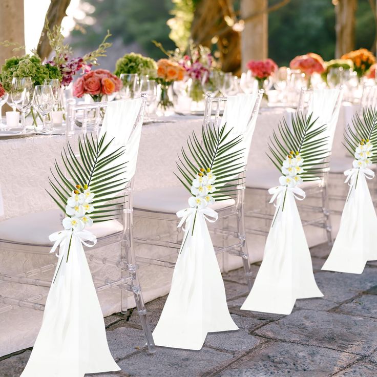 there are many chairs that have been set up on the table for an outdoor wedding