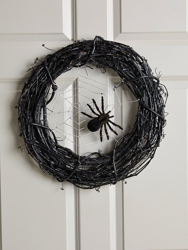 a spider wreath hanging on the front door