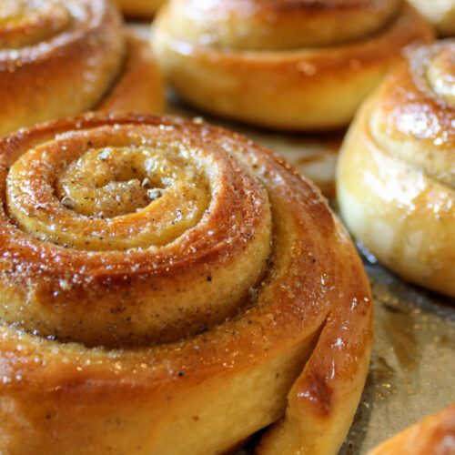 several cinnamon rolls sitting on top of a baking sheet